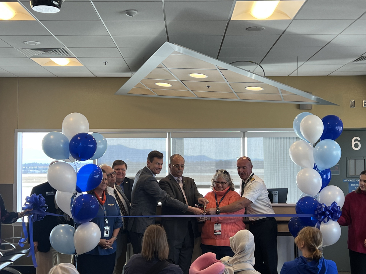 A group of people at a ribbon cutting ceremony