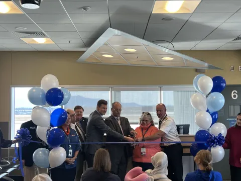 A group of people at a ribbon cutting ceremony